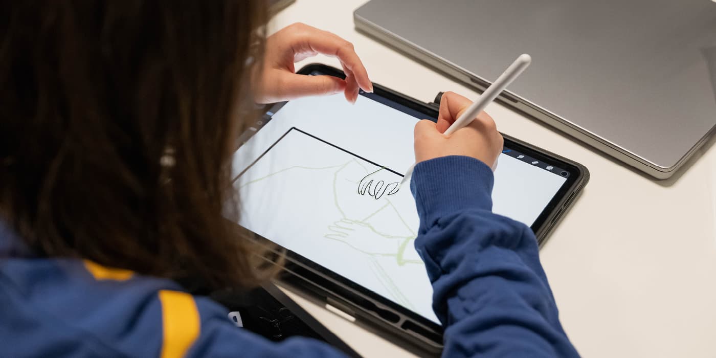 Student designing on tablet